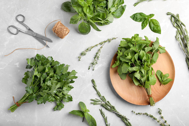 Flat lay composition with fresh green herbs on grey background - Fotografie, Obrázek