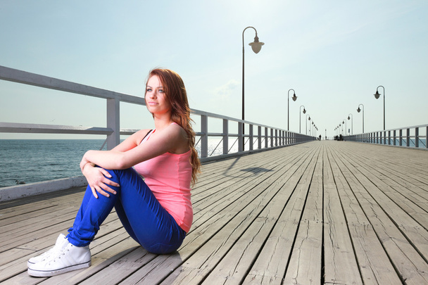 Attractive girl Young woman pier sea - 写真・画像