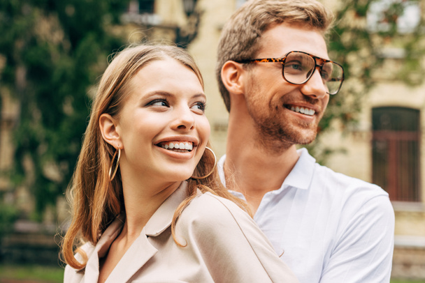 close-up portrait of smiling young couple in stylish clothes looking away - Photo, Image