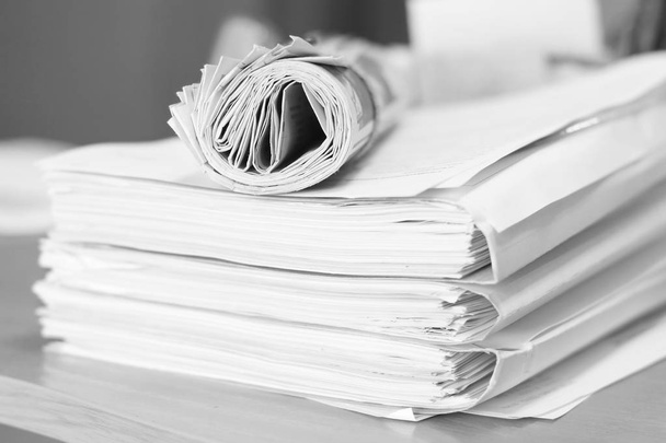 Paperwork and rolled newspaper       - Photo, Image