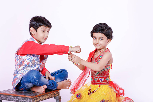 cute Indian brother and sister celebrating raksha bandhan festival , - Photo, Image