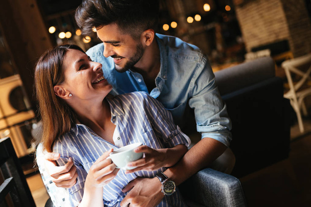 Young attractive cheerful couple on date in coffee shop - Fotoğraf, Görsel