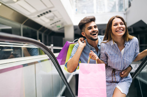 Happy attractive loving couple enjoy spending time in shopping together - Foto, imagen