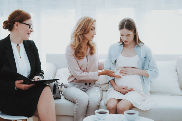 Mother with Pregnant Daughter in Doctor Office. Visit to Family Doctor. Consulting Psychologist. Healthy Pregnancy Concept. Young Mother. Worried Mother. Pregnant Girl. Psychological Help. - Φωτογραφία, εικόνα