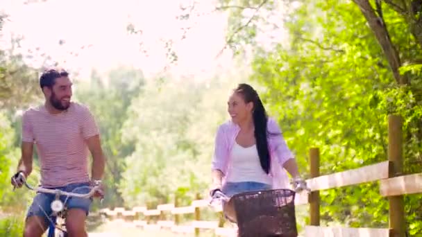 happy couple riding bicycles at summer park - Metraje, vídeo