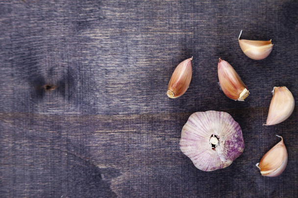 Garlic in a dark wooden background.  - Fotografie, Obrázek
