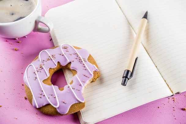 Rest and relaxation concept, coffee cup and biscuits donut with sugar coating, with a notepad for notes or wishes on a bright trendy background, top view space for text - Φωτογραφία, εικόνα