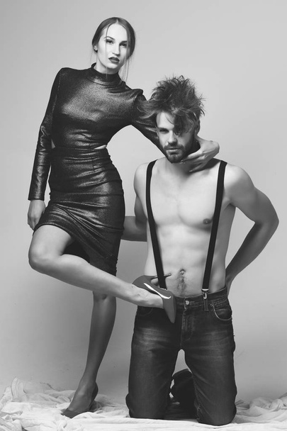 Man and pretty girl with seductive faces on grey background - Valokuva, kuva