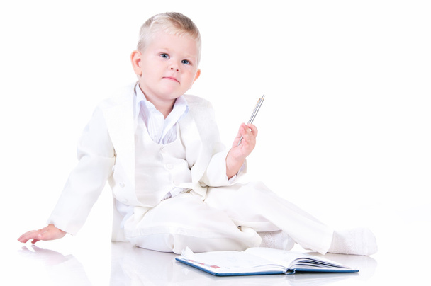 Cute baby in a white business suit with a diary - Foto, Bild