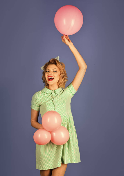 Pin up woman in balloons, birthday. Retro woman with party balloons, celebration. - Foto, afbeelding