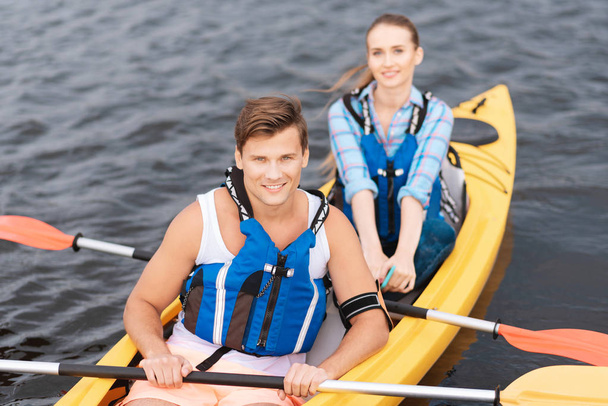 Handsome man enjoying sport activity while rowing in canoe - Photo, Image