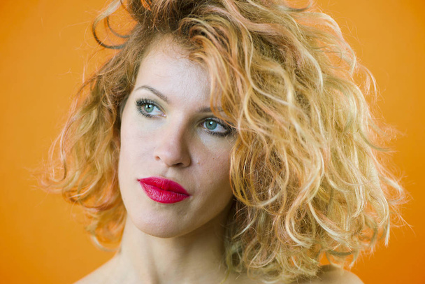 face of a pretty girl with curly hair and red lips closeup - Photo, image