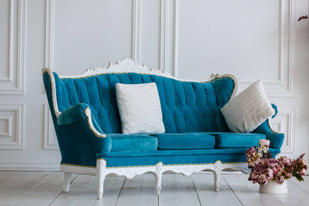 Класичний синій диван у розкішній білій кімнаті. штучний камін
 - Фото, зображення