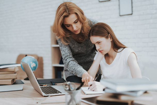 Angry Mother Motivate Daughter to do Homework. Daughter with Laptop. Mother and Daughter at Home. Teenage Girl. Education at Home Concept. Women Using Digital Device. Studying Girl. - Фото, изображение