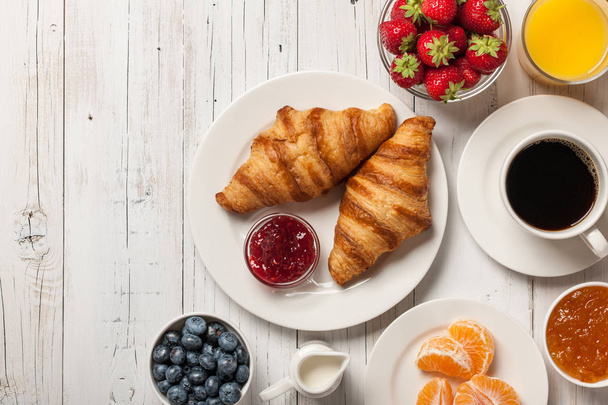 Breakfast with croissants, coffee, jams and berries - Фото, изображение