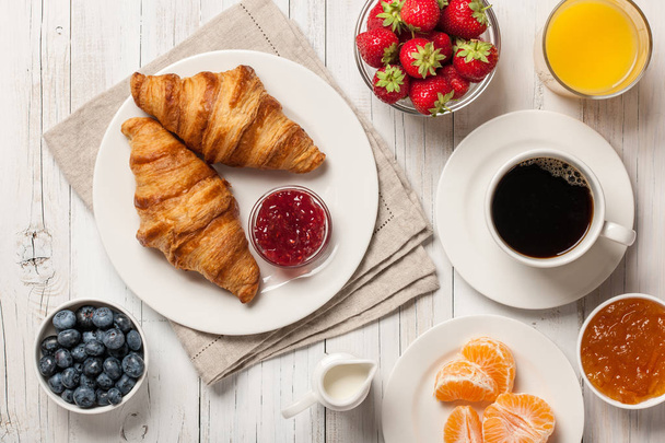 Breakfast with croissants, coffee jams and berries - Фото, изображение
