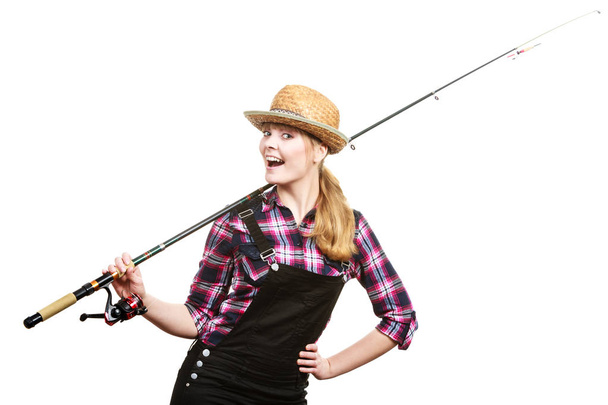 スピニング、釣り、陽気な漁師の概念。楽しいと笑顔を持って、釣竿を保持している太陽の帽子の幸せな女性. - 写真・画像