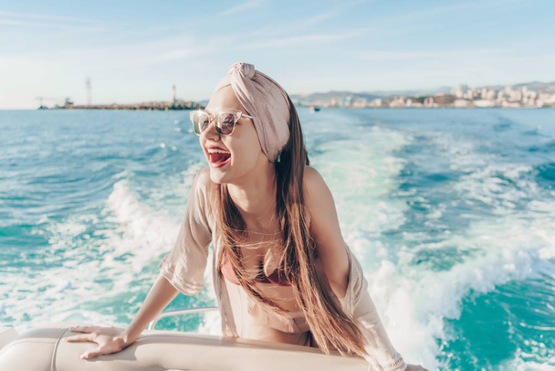 cheerful stylish girl in sunglasses enjoys sea adventure and summer heat - Фото, зображення