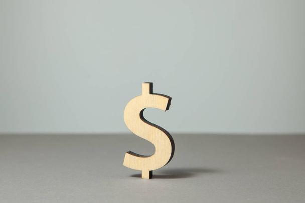 Símbolo de dólar feito de madeira no fundo cinza
 - Foto, Imagem
