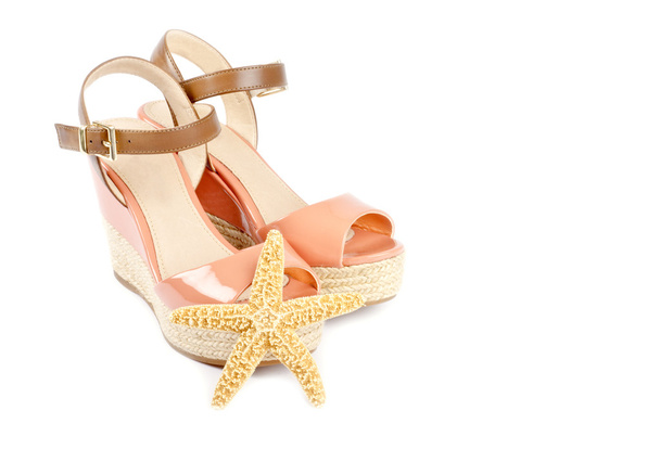 perzik gekleurde sandalen en starfish - Foto, afbeelding