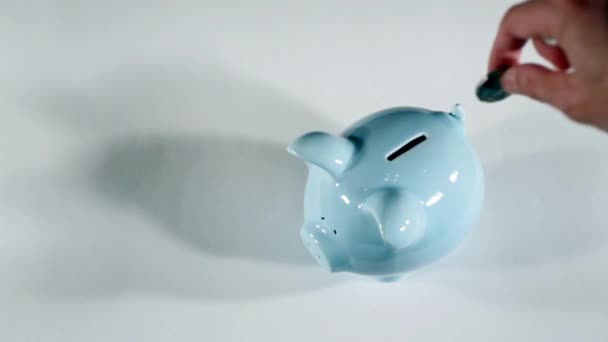 Putting coins in piggy bank, saving money - Footage, Video