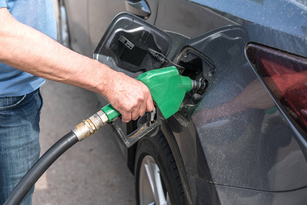 Hand refilling the car with fuel - Foto, imagen