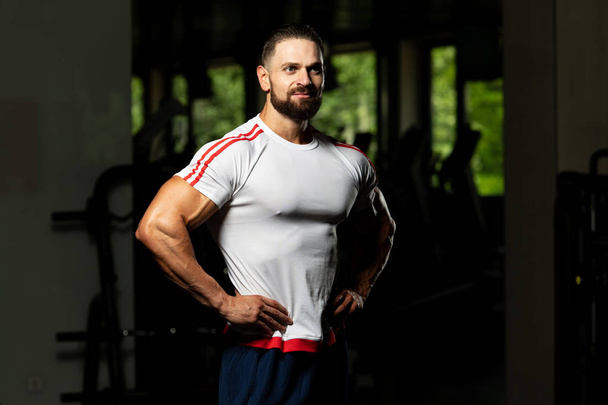 Portrait Of Personal Trainer In Sports Outfit In Fitness Center Gym Standing Strong - Zdjęcie, obraz