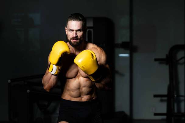 Handsome Man In Yellow Boxing Gloves - Boxing In Gym - The Concept Of A Healthy Lifestyle - The Idea For The Film About Boxing - Foto, imagen