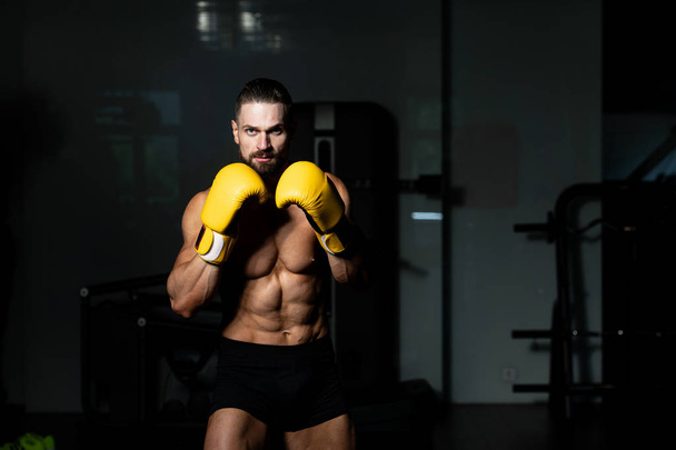 Handsome Man In Yellow Boxing Gloves - Boxing In Gym - The Concept Of A Healthy Lifestyle - The Idea For The Film About Boxing - Foto, Bild