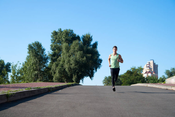 runner on sunny road. man runner training outdoor. runner athlete workout. confident runner. - Fotó, kép