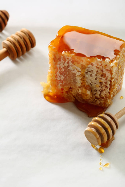 Natural sweet honey and sticks on white, food close-up - Foto, immagini