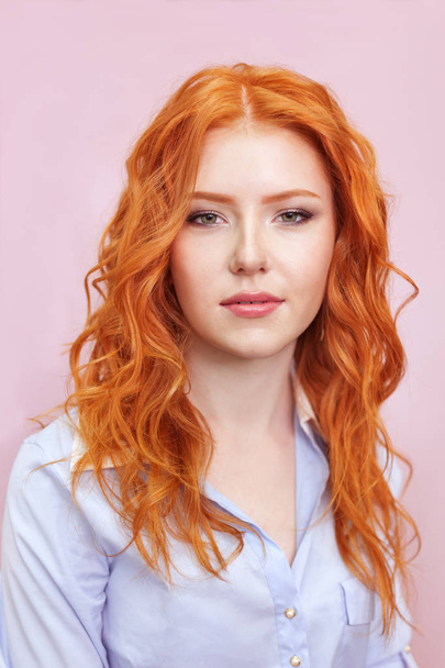 Portrait of beautiful red-haired girl on pink background. - Valokuva, kuva