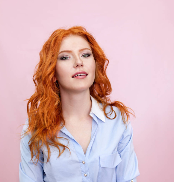 Portrait of beautiful red-haired girl on pink background. - Fotografie, Obrázek
