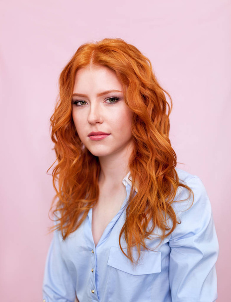 Portrait of beautiful red-haired girl on pink background. - Foto, immagini