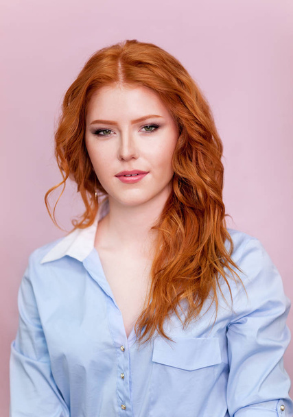 Portrait of beautiful red-haired girl on pink background. - Photo, image