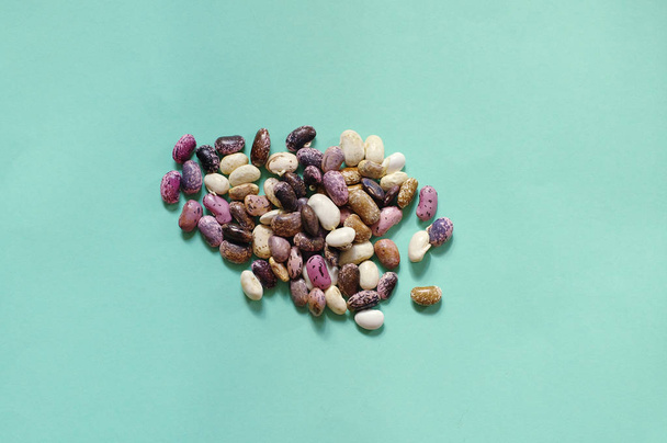 Collection set of various dried kidney legumes haricot beans close up isolated on blue background.  Healthy food.  - Foto, afbeelding