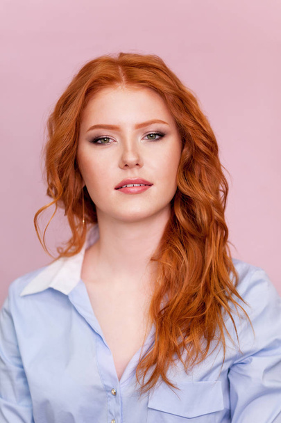 Portrait of beautiful red-haired girl on pink background. - Foto, Imagem