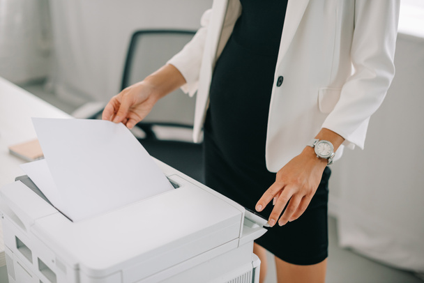 partial view of pregnant businesswoman using printer in office - Photo, Image