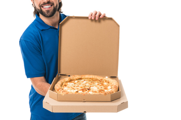 cropped shot of smiling delivery man holding pizza in boxes isolated on white - Photo, image
