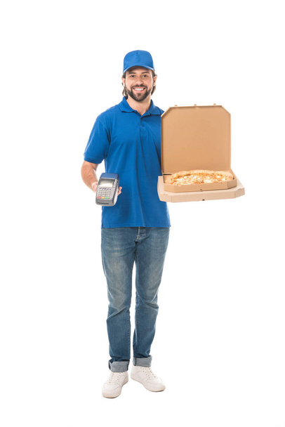 handsome delivery man holding pizza in boxes and payment terminal, smiling at camera isolated on white   - Foto, afbeelding