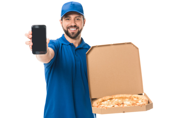happy delivery man holding smartphone and pizza in box isolated on white   - Photo, Image