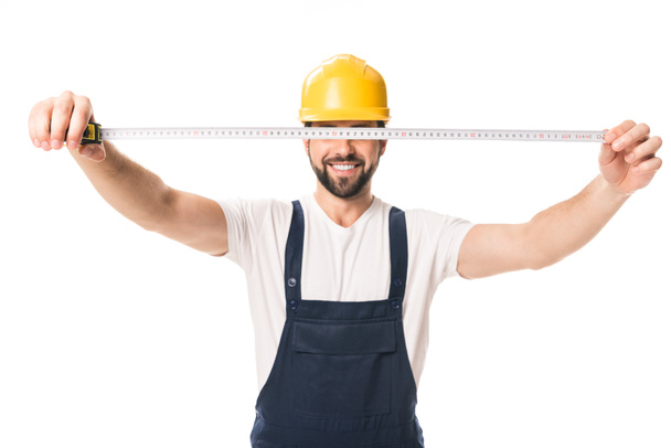 handsome happy workman holding measuring tape isolated on white - Foto, immagini