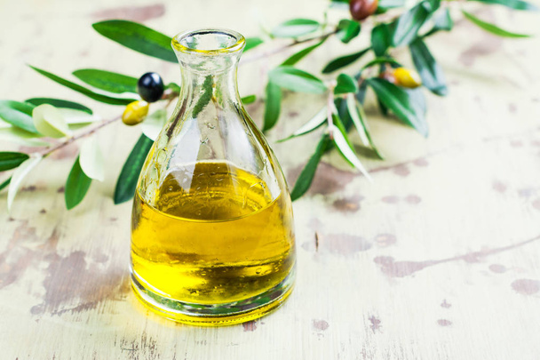 Olive oil in a glass bottle - Фото, изображение