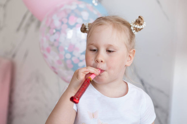 Cheerful girl blowing party whistle, fun time, happiness concept. - Fotoğraf, Görsel
