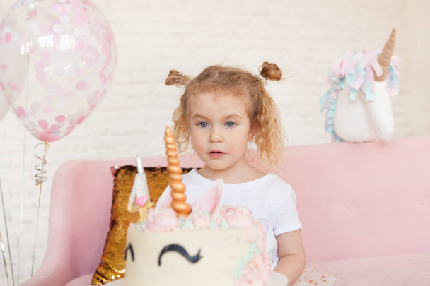 fun birthday with pretty little girl. Festive party with a unicorn, indoor - Photo, image
