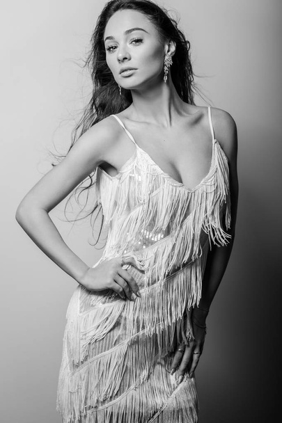 Young beautiful woman in white dress black-white studio portrait. - Foto, Imagem