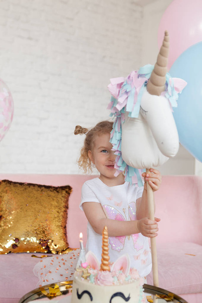 fun birthday with pretty little girl. Festive party with a unicorn, indoor - Фото, изображение