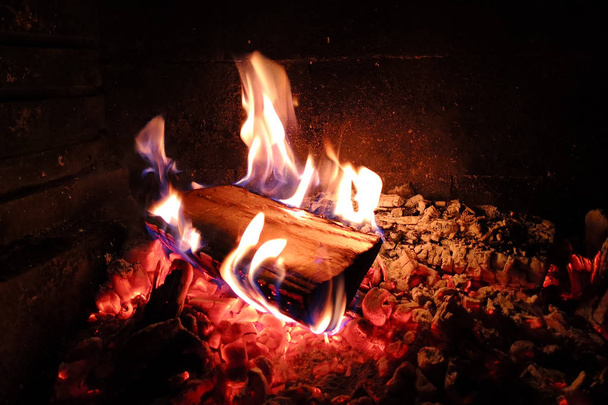 Shaped flame of fire from burning wood on a black background. - Photo, Image