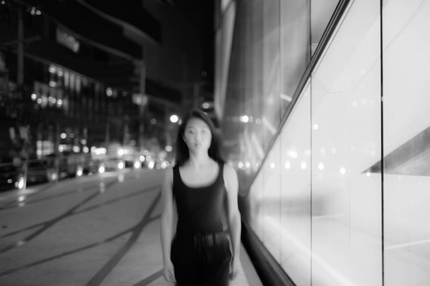 Black And White Long Exposure Portrait With Motion Blur Of Asian Woman At Night - Photo, Image