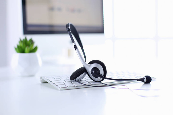 Communication support, call center and customer service help desk. VOIP headset on laptop computer keyboard - Φωτογραφία, εικόνα